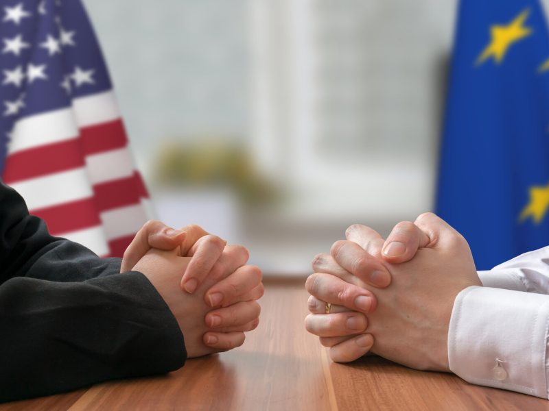 Negotiation of USA and European Union. Statesman or politicians with clasped hands.